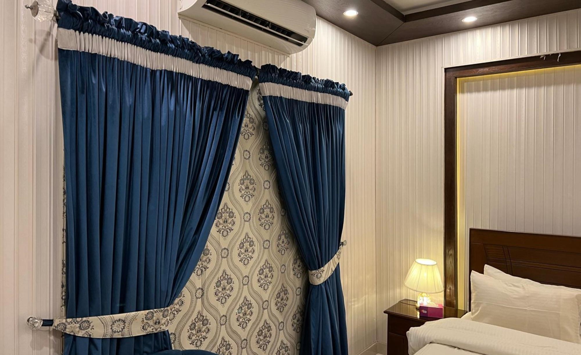 Bedroom curtains setup with upholstered chair